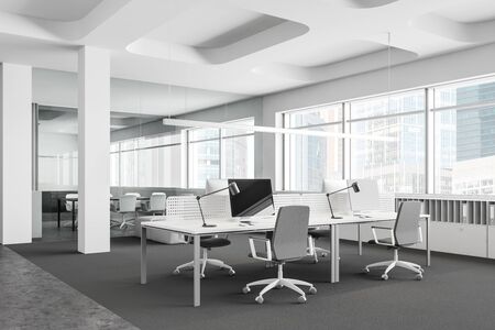 Corner of panoramic open space office with white walls, concrete floor, computer tables with gray chairs standing on carpet and glass wall meeting room in background. 3d renderingの写真素材