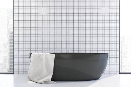 Interior of minimalistic bathroom with white tile walls, concrete floor, comfortable grey bathtub and windows with cityscape. 3d renderingの写真素材