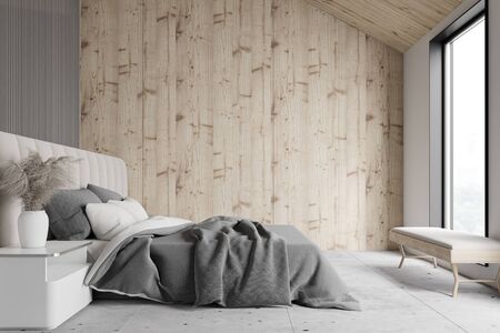 Side view of attic master bedroom with white, gray and wooden walls, stone floor and comfortable...