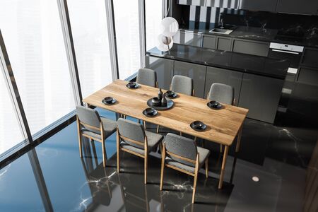 Top view of panoramic kitchen with black marble walls and floor, grey countertops and wooden dining...