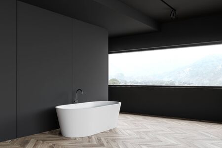 Corner of minimalistic bathroom with dark gray walls, wooden floor, comfortable bathtub and big...