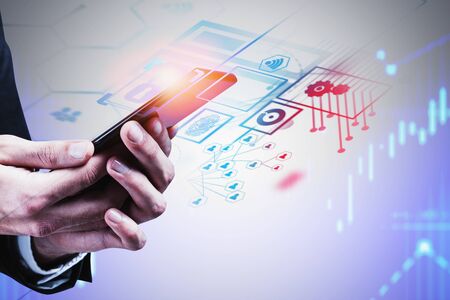 Hands of businessman using smartphone with double exposure of immersive business interface over...