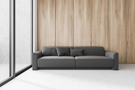 Interior of spacious minimalistic living room with wooden walls, concrete floor, comfortable grey...