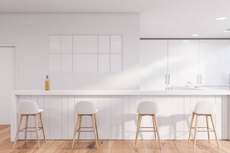 Interior of traditional pub with white walls, wooden floor, white bar counter and row of white...