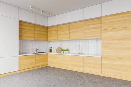 Corner of minimalistic spacious kitchen with white tile walls, concrete floor, wooden cupboards and countertops with built in appliances. 3d renderingの写真素材