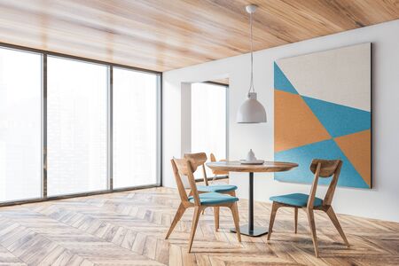 Corner of spacious panoramic dining room with white walls, wooden floor, round table with blue chairs and abstract picture and window with blurry cityscape. 3d renderingの写真素材
