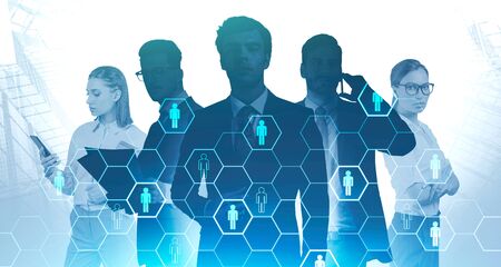 Silhouettes of successful business people in abstract city with double exposure of blurry HR interface. Concept of recruitment and job search. Toned imageの写真素材