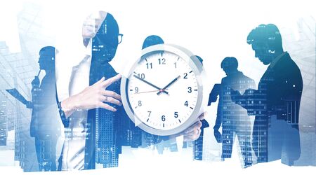 Silhouettes of business people brainstorming and working in abstract blurry city with double...