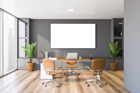 Interior of panoramic CEO office with gray walls, wooden floor, comfortable computer table with...