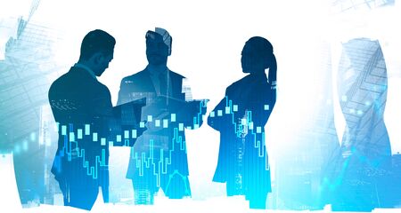 Silhouettes of business people in abstract city with double exposure of blurry digital graphs....