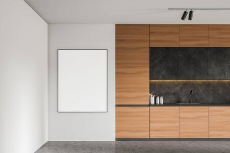 Vertical mock up poster frame hanging in spacious loft kitchen with white walls, concrete floor, comfortable wooden countertops with built in sink and dark grey cupboards. 3d renderingの写真素材