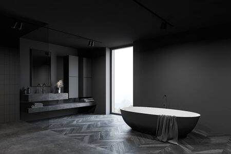 Corner of luxury hotel bathroom with dark grey walls, wooden floor, comfortable big bathtub, massive stone sink with vertical mirror and window with blurry mountain view. 3d renderingの写真素材
