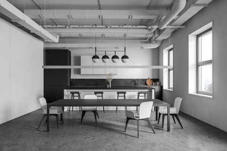 Interior of industrial style kitchen with white and grey walls, concrete floor, gray countertops, bar with stools and dining table with white chairs. 3d renderingの写真素材