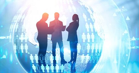 Silhouettes of business people over planet hologram with double exposure of blurry network...