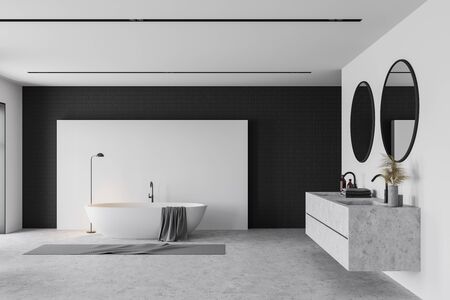 Interior of modern bathroom with white and black brick walls, concrete floor, comfortable white bathtub and stone double sink with two round mirrors. 3d renderingの写真素材