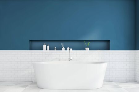 Interior of modern bathroom with blue and white brick walls, tiled floor, comfortable white bathtub and shelf with beauty products. 3d renderingの写真素材