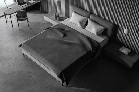 Top view of stylish master bedroom in Scandinavian style with grey and wooden walls, concrete floor,...
