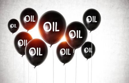 Black balloons with oil written on them over concrete wall background. Concept of oil market bubble and crisis. 3d renderingの写真素材