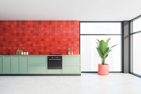 Interior of minimalistic kitchen with red tiled and gray walls, concrete floor, olive countertops with built in sink and cooker and windows with blurry cityscape. 3d renderingの写真素材