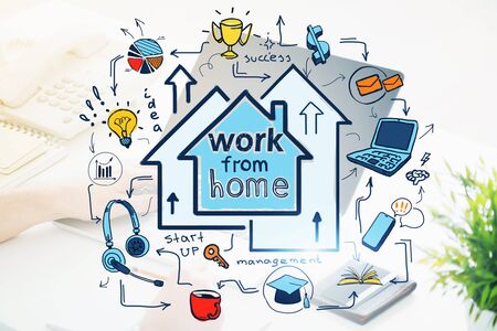 Hands of businessman typing on laptop at blurry home office table with double exposure of colorful work from home sketch. Concept of freelance. Toned imageの写真素材