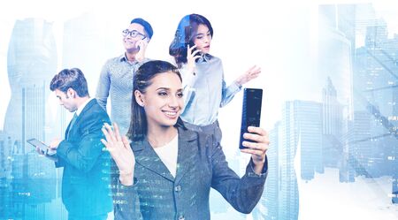 Four diverse business people using gadgets in abstract city. Concept of communication and teamwork....