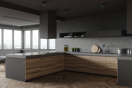 Corner of modern kitchen with grey and stone walls, wooden floor, comfortable wooden countertops with built in cooker and sink and shelf for dishes. Window with blurry mountain view. 3d renderingの写真素材