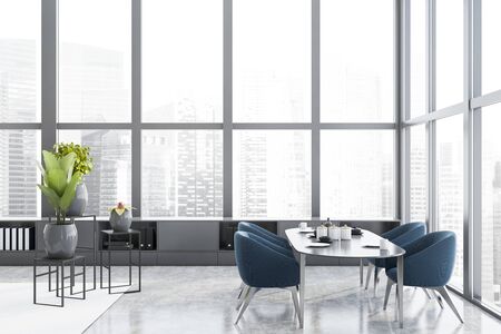 Side view of modern panoramic dining room with concrete floor, long oval gray table with blue...