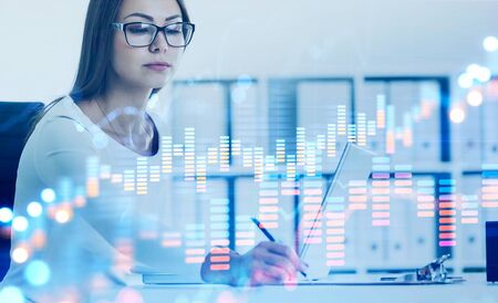Beautiful young businesswoman in glasses taking notes in blurry office with double exposure of...