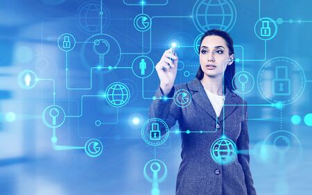 Beautiful young European businesswoman using immersive business interface over blurry background. Concept of hi tech and internet. Toned image double exposureの写真素材