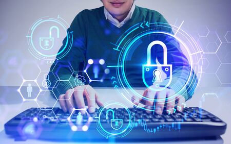 Unrecognizable young businessman typing on keyboard with double exposure of blurry futuristic cyber...