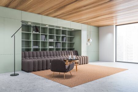 Corner of panoramic living room with green walls, concrete floor, brown sofa and armchair standing...