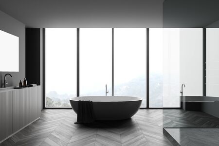 Interior of stylish bathroom with dark gray walls, wooden floor, comfortable bathtub, cozy shower stall and wooden double sink with big mirror. Blurry mountain view. 3d renderingの写真素材