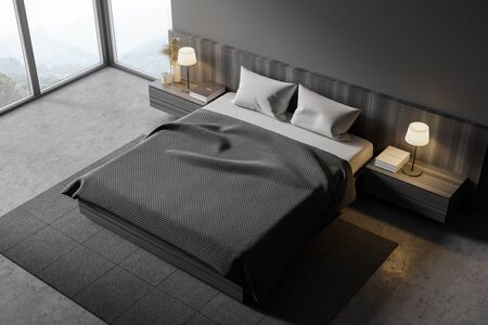 Top view of stylish master bedroom with gray walls, concrete floor, comfortable king size bed and...