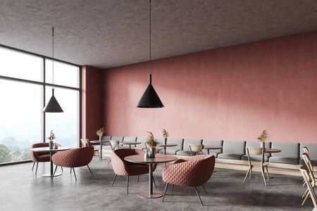 Corner of panoramic restaurant with pink walls, concrete floor, round tables with comfortable pink armchairs, gray sofa and wooden chairs. Window with blurry mountain view. 3d renderingの写真素材