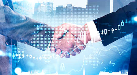 Two businessmen shaking hands in abstract city with double exposure of financial graph and digital...