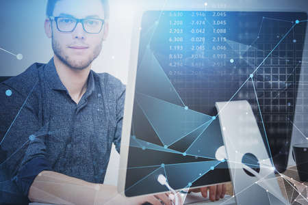 Bearded young engineer in glasses using computer in blurry office with double exposure of immersive...