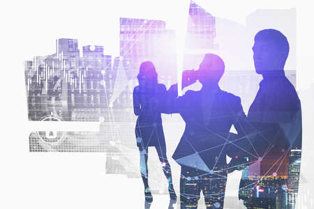 Silhouettes of business team members working together in blurry abstract night city with double exposure of HUD network interface. Concept of communication and internet. Toned imageの写真素材