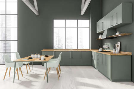 Front view of stylish kitchen with gray brick walls, wooden floor, gray countertops and dining table...