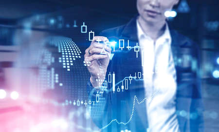 Unrecognizable businesswoman working with futuristic financial interface in blurry office. Concept...