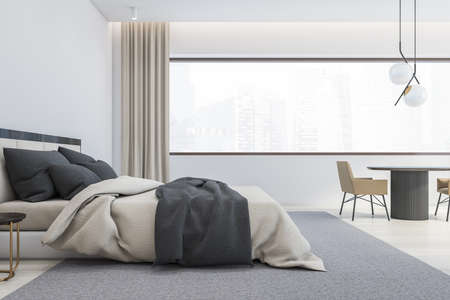 Interior of modern master bedroom with white walls, wooden floor, comfortable king size bed with round bedside tables and round table with beige armchairs. Window with blurry cityscape. 3d renderingの写真素材