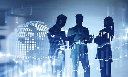 Three traders working together in blurry office with double exposure of planet hologram and...