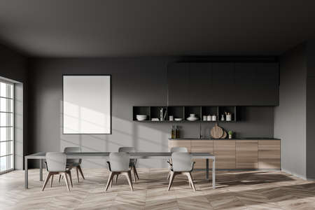 Interior of stylish kitchen with gray walls, wooden floor, long gray dining table and wooden...