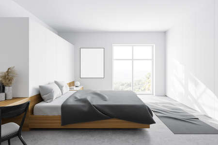 Side view of master bedroom with white walls, concrete floor, comfortable king size bed, window with blurry mountain view and vertical mock up poster. 3d renderingの写真素材