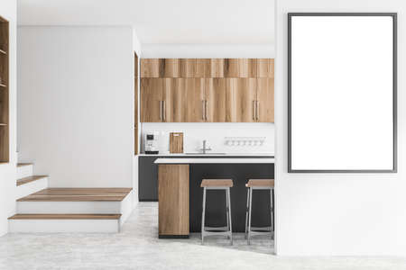 Interior of modern kitchen with white brick walls, concrete floor, wooden cupboards, bar with stools and gray cabinets. Stairs and mock up poster frame. 3d renderingの写真素材