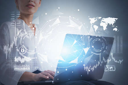 Unrecognizable young businesswoman using laptop over gray background with double exposure of network...