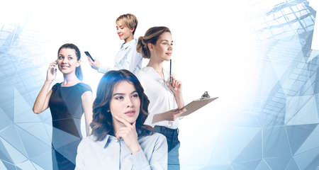 Portrait of four beautiful young businesswomen working together in blurry abstract city. Concept of teamwork. Toned image double exposureの写真素材