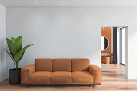 Interior of modern living room with white walls, wooden floor and comfortable brown sofa. 3d...