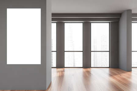 Interior of empty office with gray walls, wooden floor and panoramic window. Blurry cityscape and...