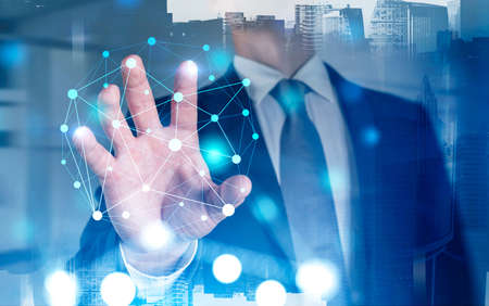 Unrecognizable young businessman working with immersive network interface in blurry office. Toned...