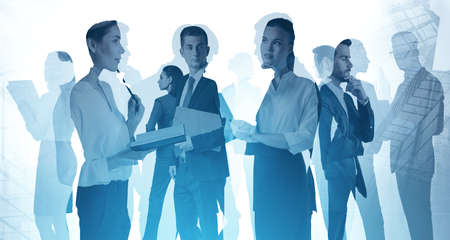 Silhouettes of business people working together in blurry abstract city. Concept of collaboration....